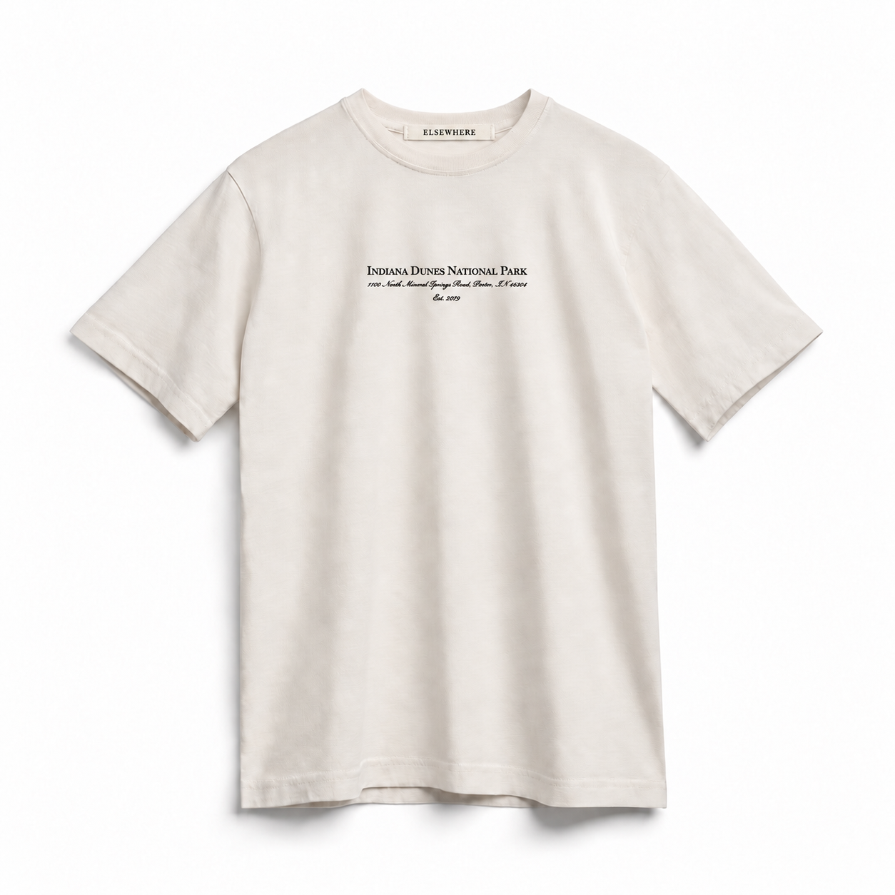 An off-white short-sleeve t-shirt with black text on the chest reading 'INDIANA DUNES NATIONAL PARK' shown on a clean white background.